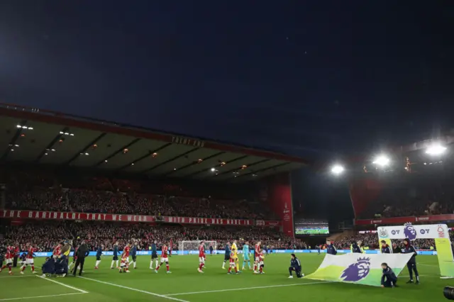 Players make their way onto the field at the City Ground.