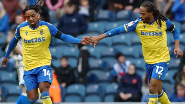 Stoke City players celebrate their first-half goal against Blackburn