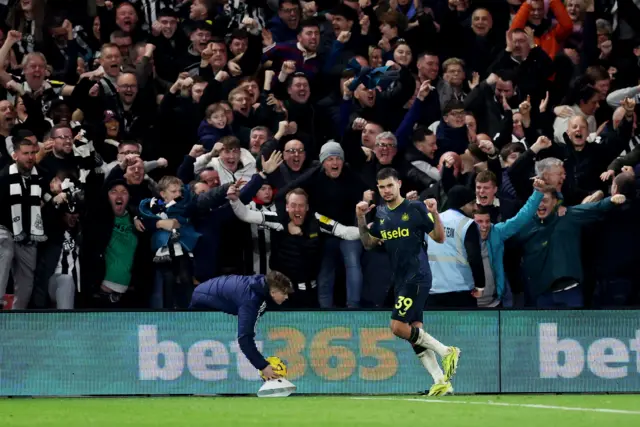 Guimaraes celebrates in front of the Newcastle fans after putting them ahead for the third time.