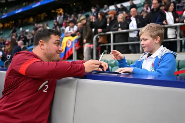 Jamie George signs an autograph