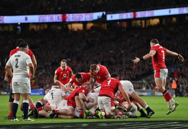 Wales and England players on the floor