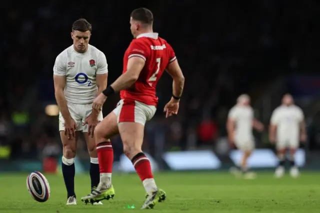 Wales hooker Elliot Lee kicks the ball off of the stand as Ford attempts to take a try conversion