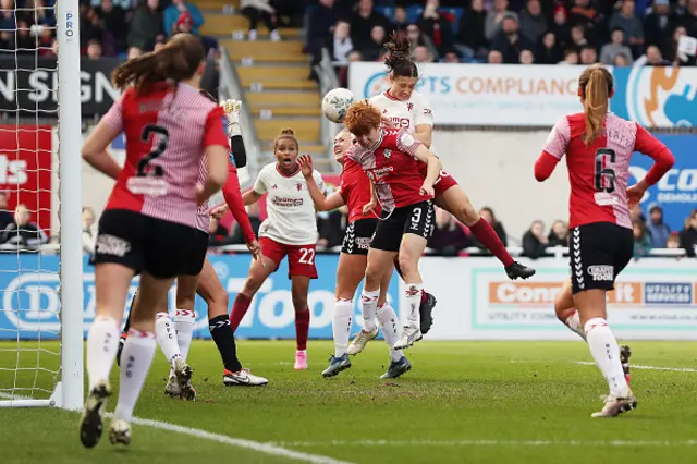 Rachel Williams jumps higher than her opposition to head the ball