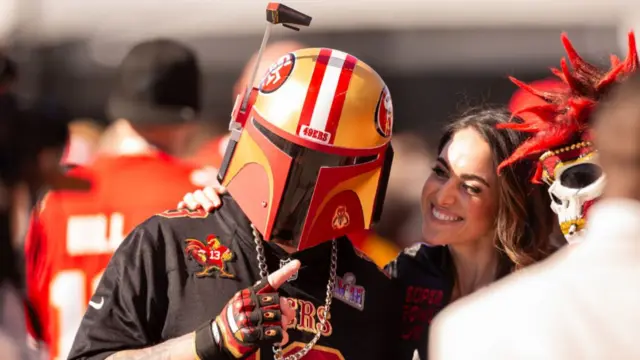 A 49ers fan in a Boba Fett-style helmet