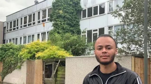 22-year-old Kwajo Tweneboa in front a social housing complex