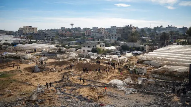 Palestinians inspect damaged areas following Israeli airstrike on Rafah, southern Gaza - 12 Feb 2024