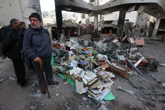 Palestinians inspect the extent of damage inside part of the Al-Huda mosque