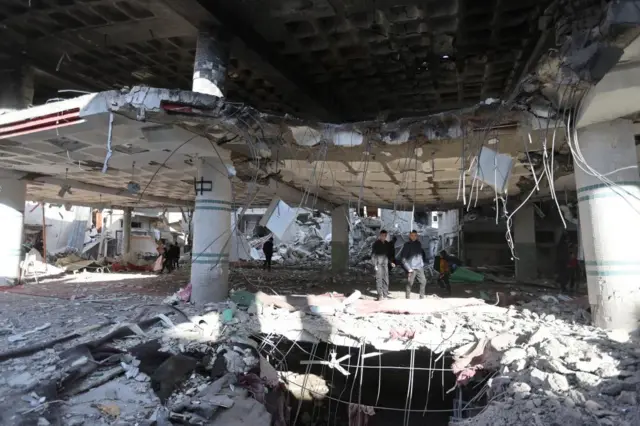 Palestinians inspect the site of an Israeli strike on the Al Huda mosque in Rafah, a city in Gaza