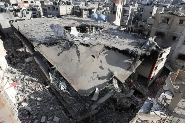 Palestinians inspect the site of an Israeli strike on the Al Huda mosque in Rafah, a city in Gaza