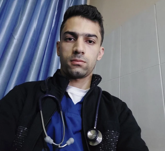 Ahmed Abuibaid, in his scrubs as an ER doctor