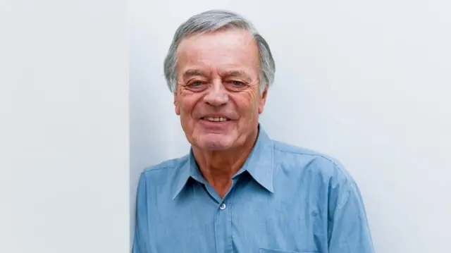 Tony Blackburn, English DJ and singer, is pictured in a blue shirt