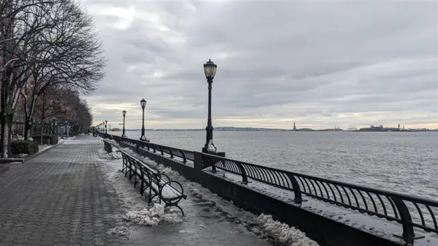 Walk way, benches, lamps, railing, water, statue