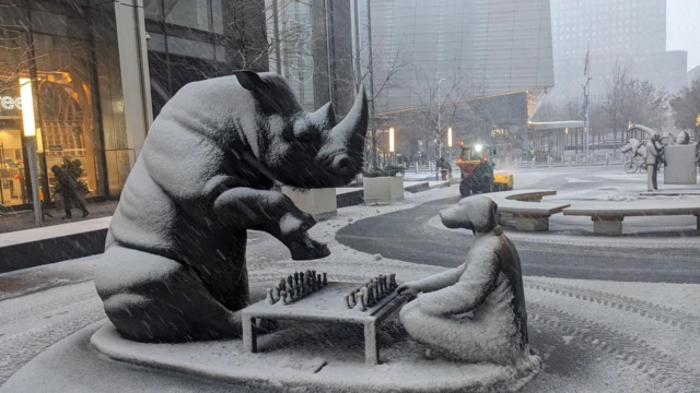 Snow falling on statues in New York