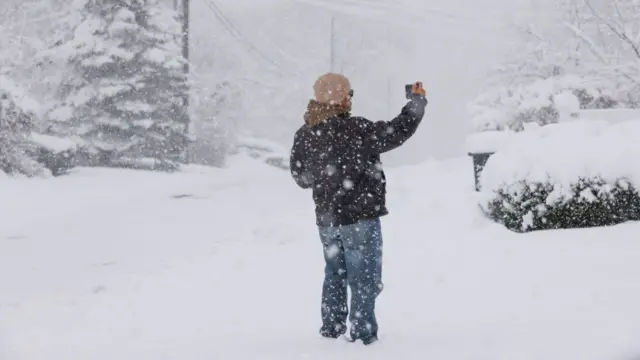 A man takes pictures of the storm in Tappan, New York, on February 13, 2024.