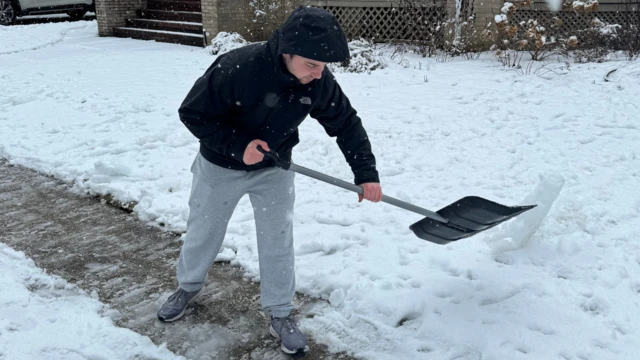 A man shovels snow in Brooklyn