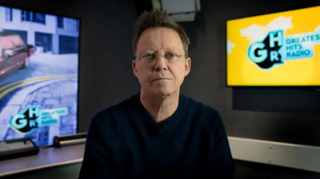 Simon Mayo poses in a BBC studio for an interview