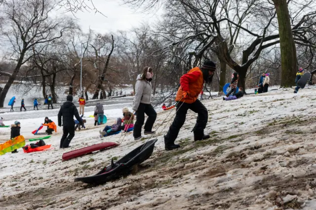 Children sled at a hill in Brooklyn's Prospect Park as a large winter storm makes its way across the area on February 13, 2024 in New York City