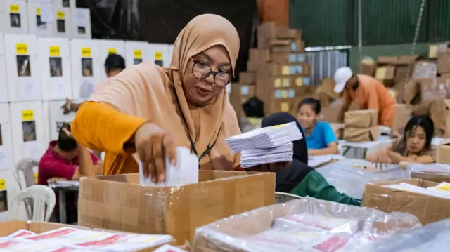 Election officer in Indonesia with ballots