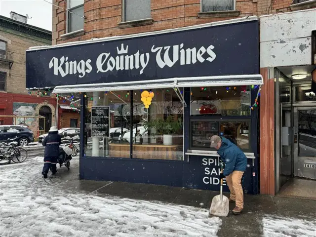 Kings County Wines storefront, sidewalk, man with shovel, postal worker