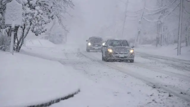 Cars driving on a snow covered road