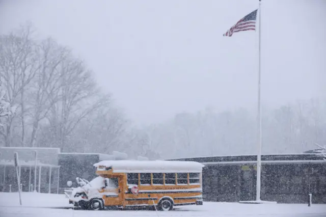 A school bus is covered in snow at a school in Northvale, New Jersey, on February 13, 2024. Heavy snowfall is expected over parts of the Northeast US starting late February 12, with some areas getting up to two inches (5cms) of snow an hour, the National Weather Service forecasters said. (Photo by Kena Betancur / AFP) (Photo by KENA BETANCUR/AFP via Getty Images)