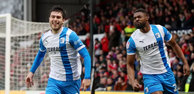 Barrow players celebrate a goal