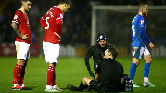 Referee Neil Hair suffers an injury in the Stockport v Crewe game