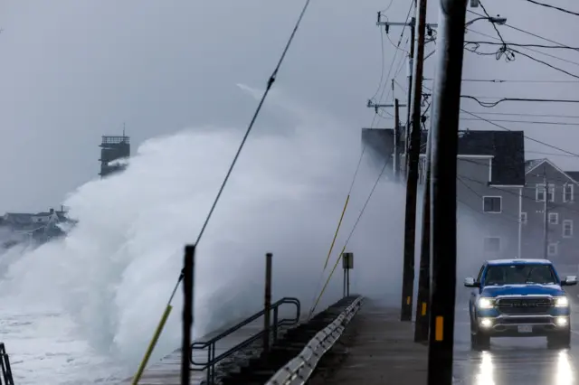 Wave, utility polls, blue truck