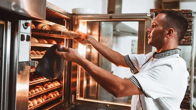 Baker working at his store