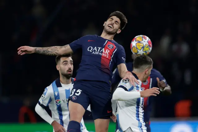 Players from PSG and Real Socieded battle for the ball.