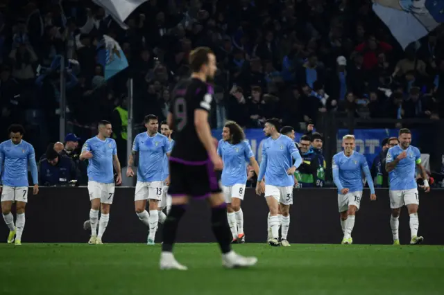 Kane stands at kick off as Lazio celebrate their goal as a team.