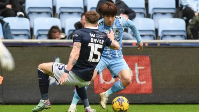 Coventry's Tatsuhiro Sakamoto takes on Joe Bryan, of Millwall