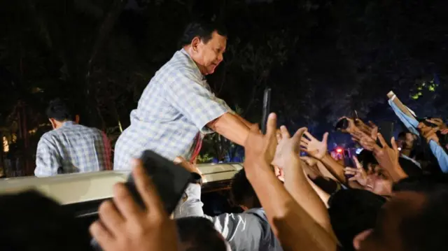 Indonesia's Defence Minister and presidential candidate Prabowo Subianto greets his supporters in Jakarta, Indonesia February 14, 2024.