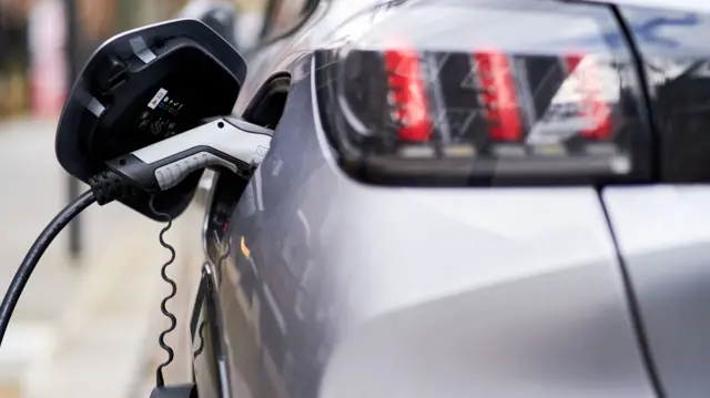 An electric car being charged up