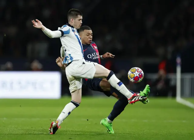 Mbappe and Zubeldia battle for the ball.