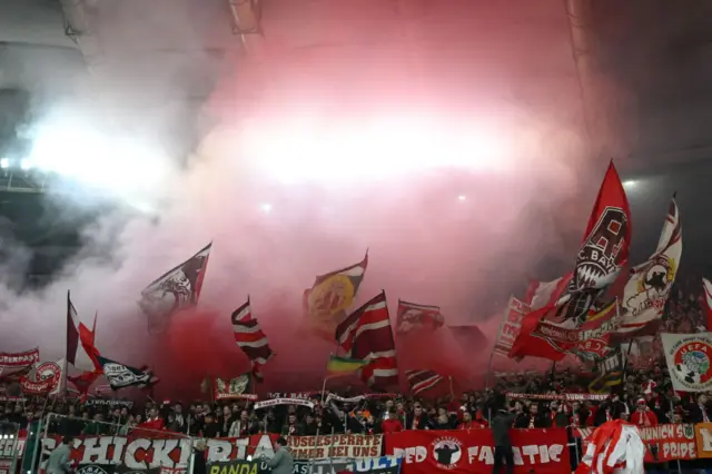 Bayern fans wave flags and set off flares at the Stadio Olimpico.