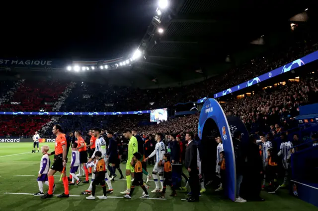 The players make their way to the pitch in Paris.