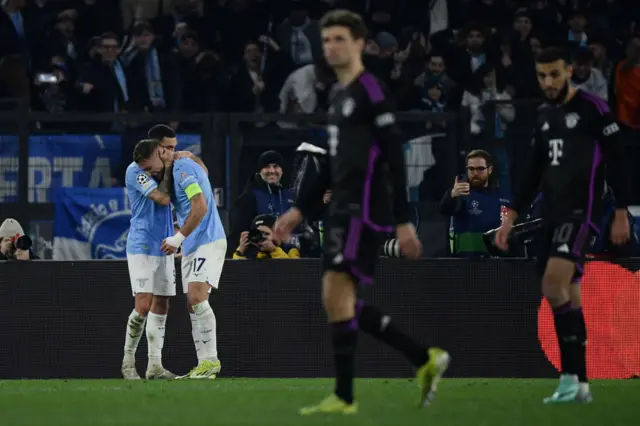 Immobile is hugged after scoring as Bayern players trudge back to kick off.