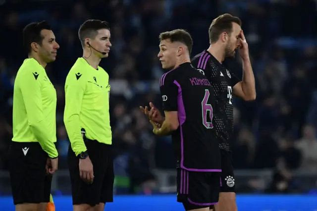 Kane and Kimmich argue with the officials after the game.