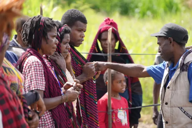 Ballots are cast into noken bags at a polling station in Konan village, Papua