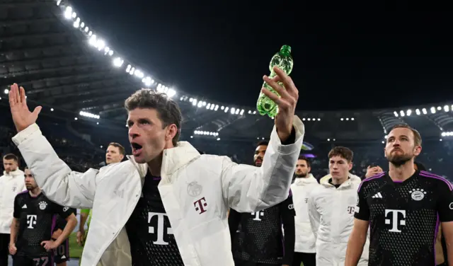 Muller waves at the Bayern fans as the squad acknowledge them.