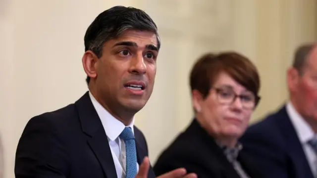 Rishi Sunak wears a suit and gestures as he speak to a Business Council meeting