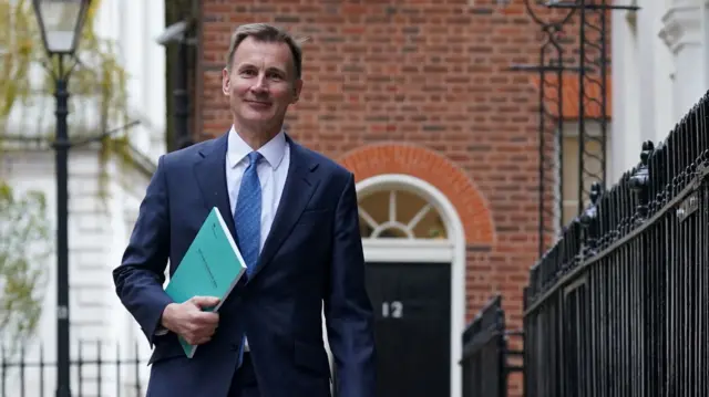 Jeremy Hunt delivering his autumn statement, walking in Downing Street