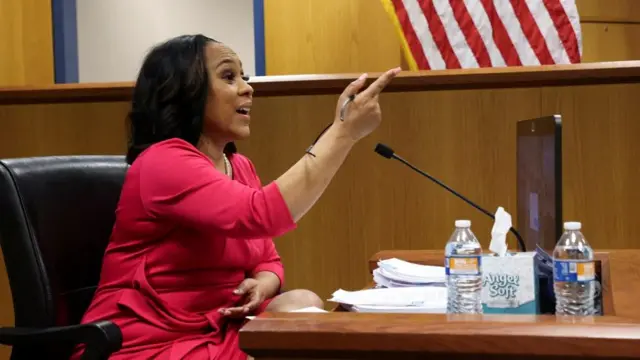 Attorney Fani Willis speaks from a witness stand during a hearing in the case of State of Georgia v. Donald John Trump at the Fulton County Courthouse in Atlanta, Georgia, U.S., February 15, 2024.