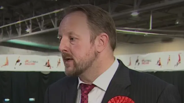 Labour MP Toby Perkins speaks at a by-election count. He is stood in a sports hall