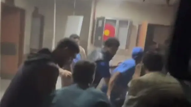 A screengrab from footage taken at Nasser hospital shows people, including in medical scrubs, appearing to run through a corridor