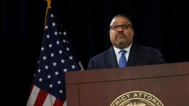 District attorney Alvin Bragg looks on during a news conference