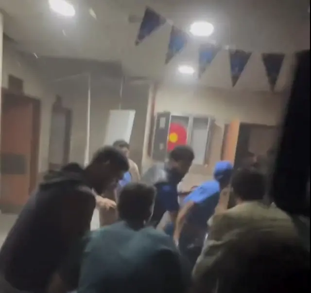 A still of a video inside Nasser hospital shows people appearing to flee in a dust- or smoke-filled corridor