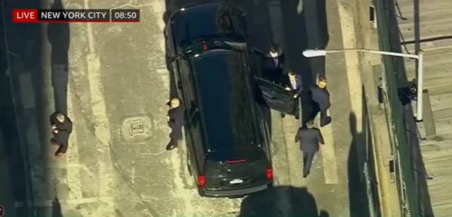 A top down view of Donald Trump getting out of his SUV