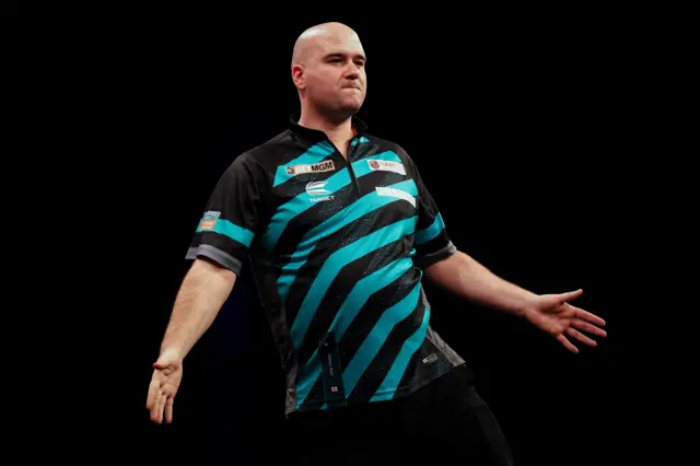 Rob Cross celebrates beating Michael Smith